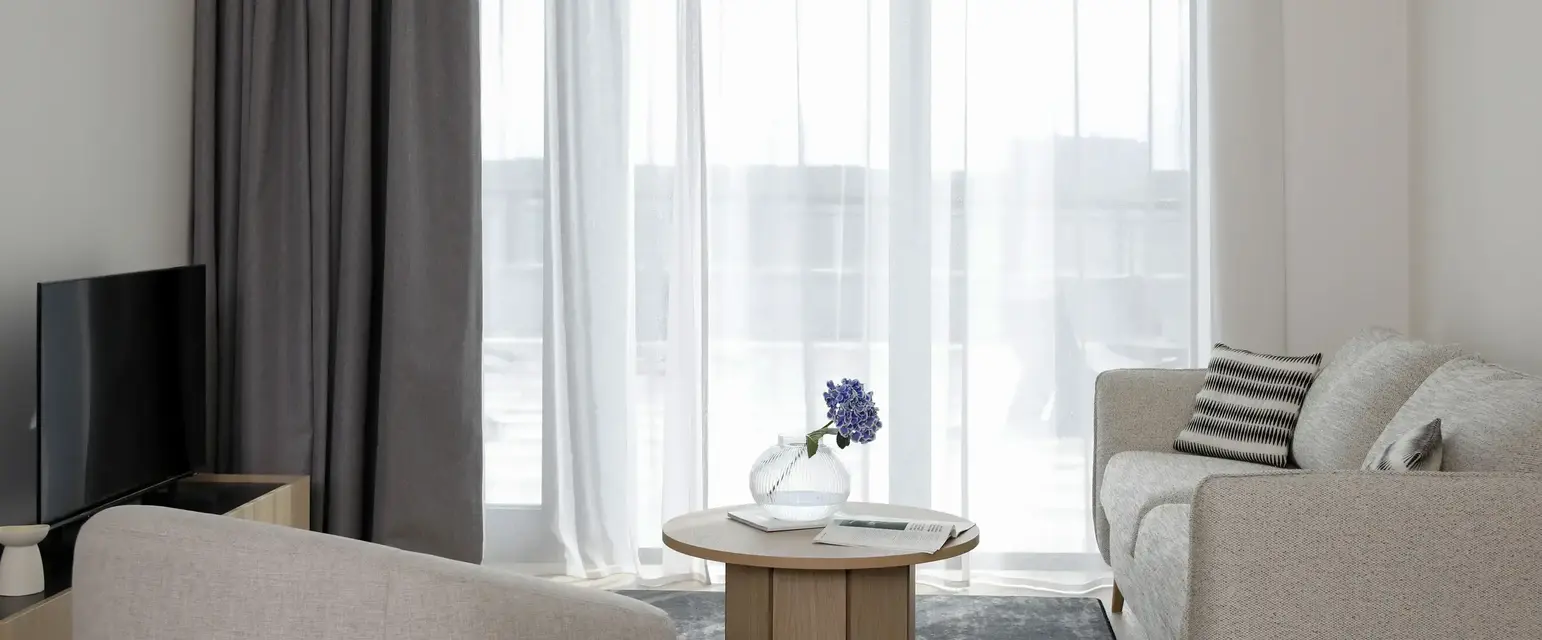 a living room with a table and chairs