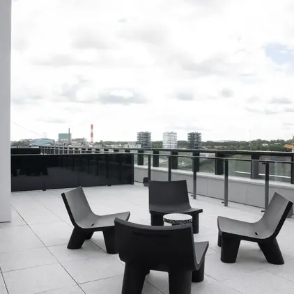 a patio with chairs and a table