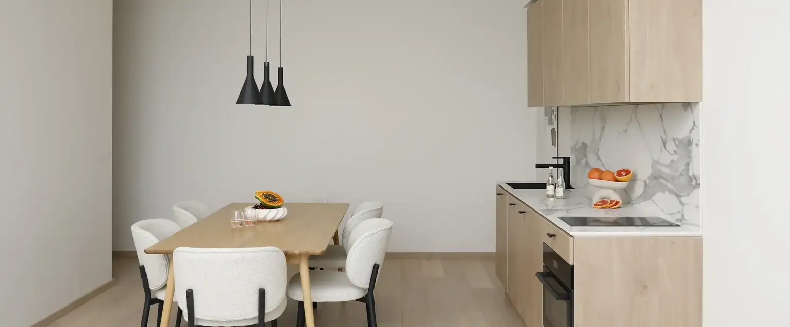 a kitchen with a table and chairs
