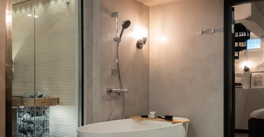 a bathroom with a tub and shower