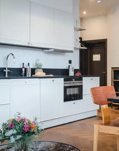 a kitchen with white cabinets and a table