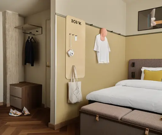 a room with a bed and a bench