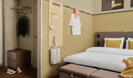 a room with a bed and a bench