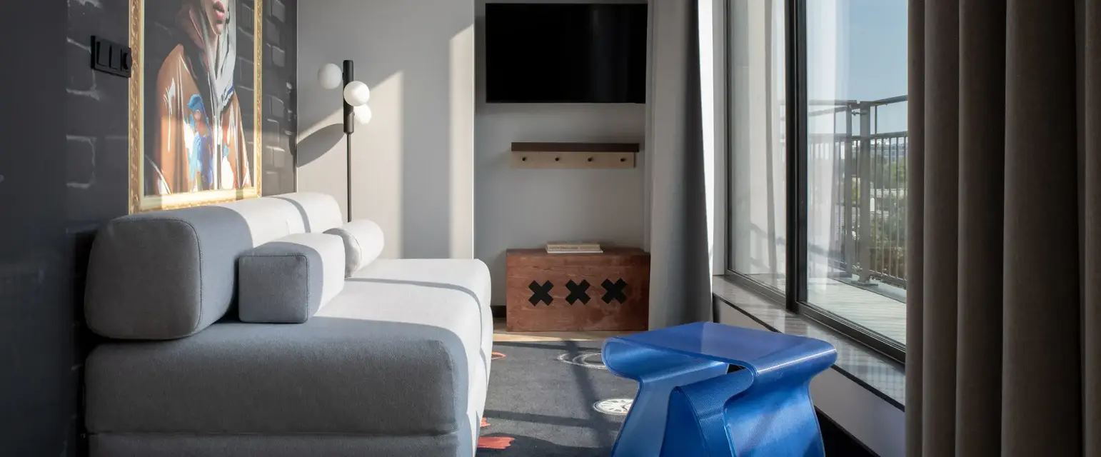 a living room with a couch and a blue plastic table