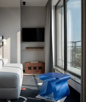 a living room with a couch and a blue plastic table
