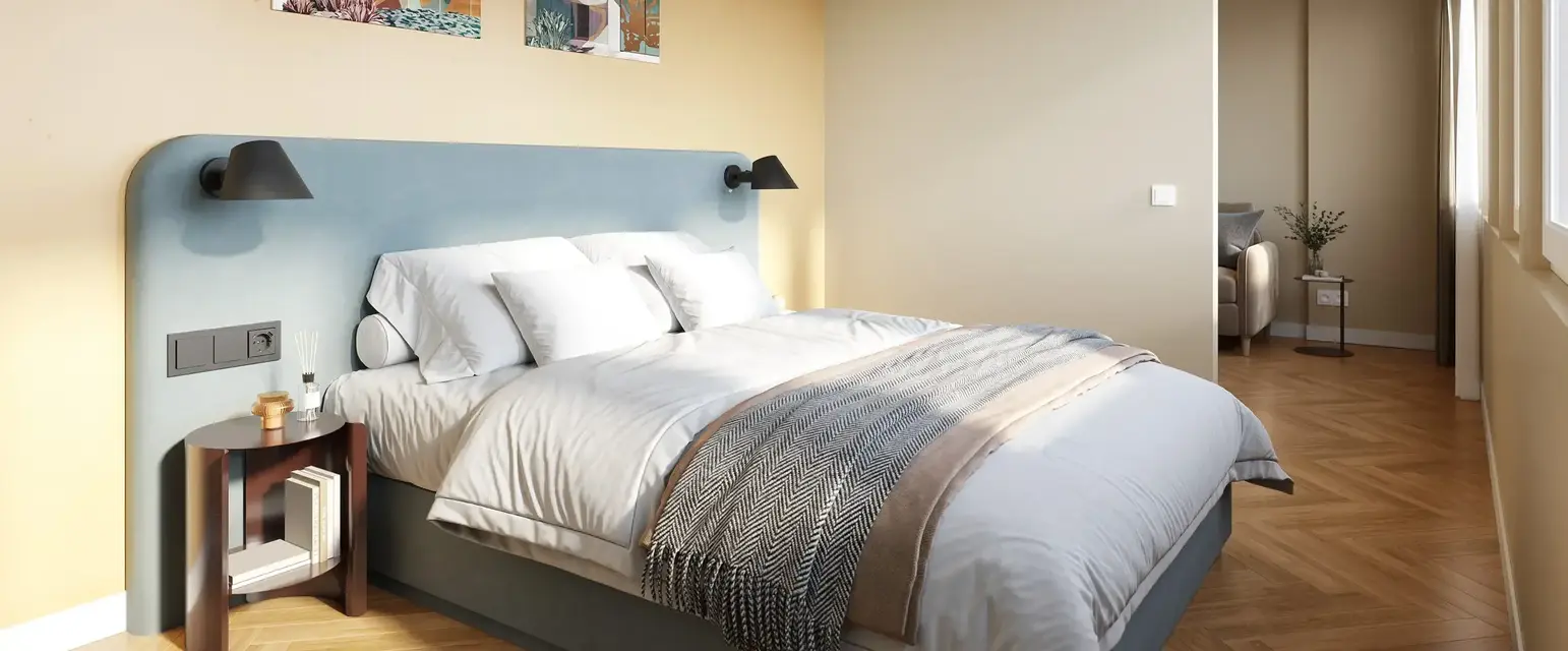 a bedroom with a bed and a lamp