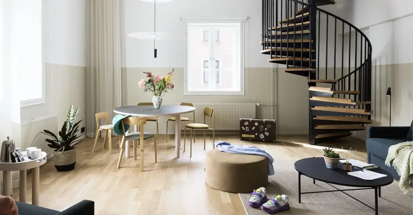 a room with a spiral staircase and a round table
