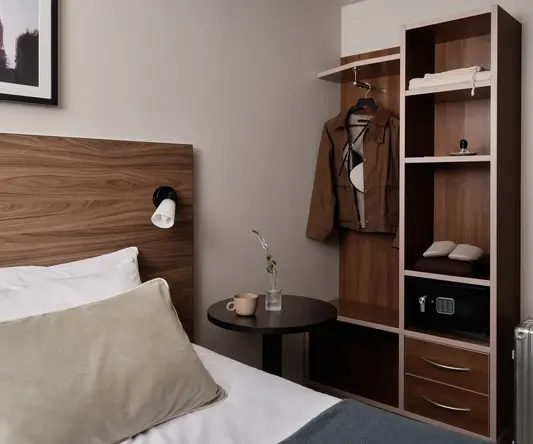 a room with a bed and a shelf