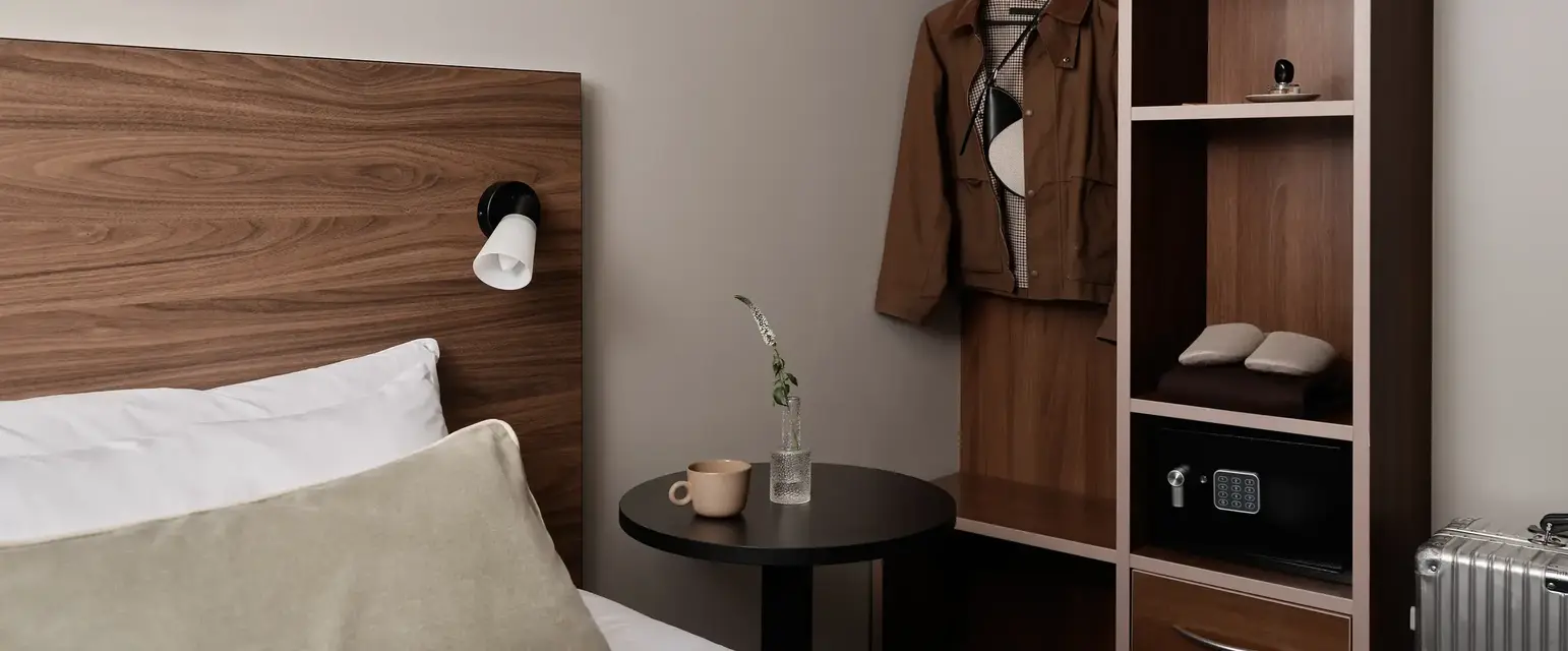 a room with a bed and a shelf