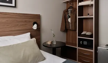a room with a bed and a shelf