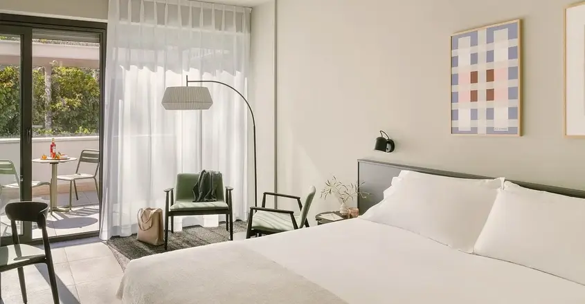 a bedroom with a bed and a chair