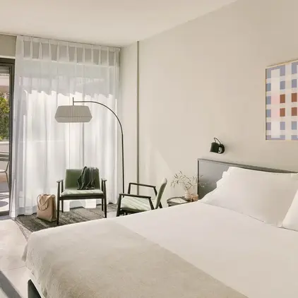 a bedroom with a bed and a chair