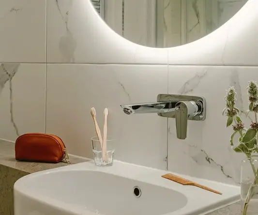a bathroom with a round mirror