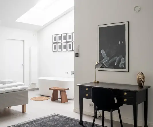 a room with a desk and a bathtub