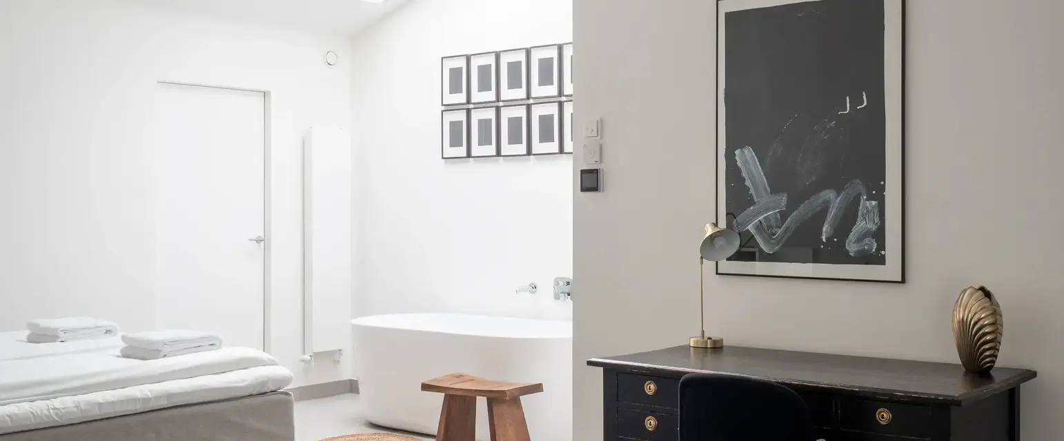 a room with a desk and a bathtub