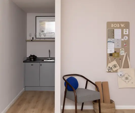 a room with a chair and a sink