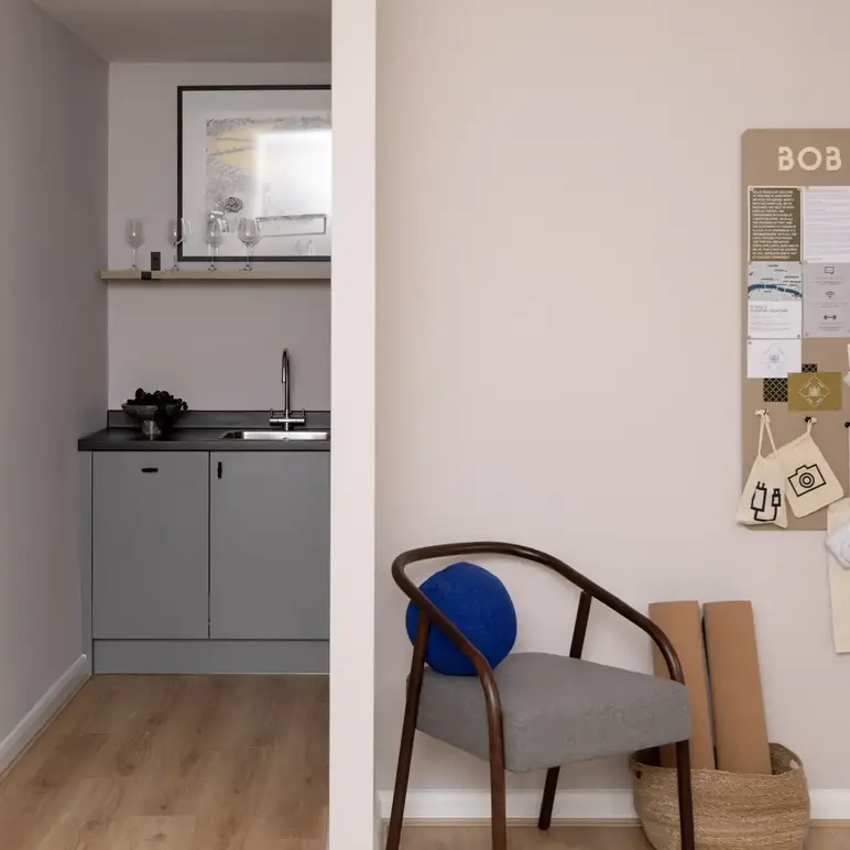 a room with a chair and a sink