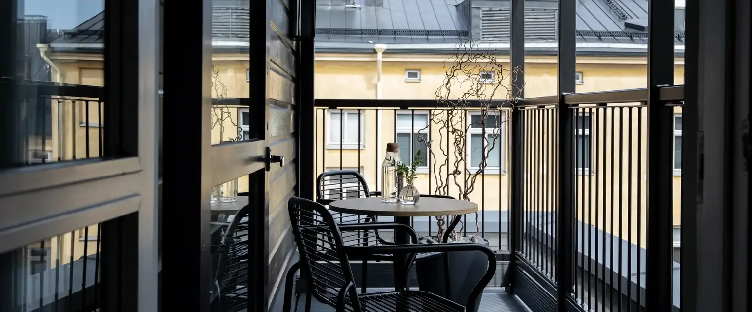 a table and chairs on a balcony