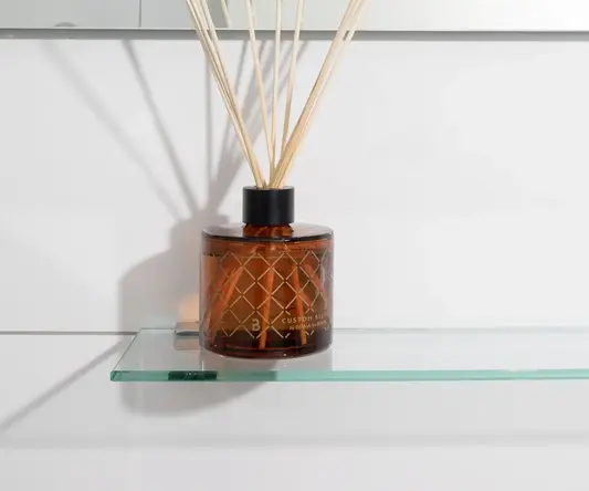 a glass bottle with sticks in it