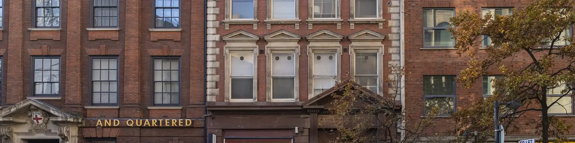 a row of buildings with a street light
