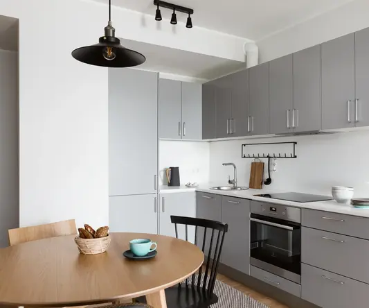 a kitchen with a table and chairs