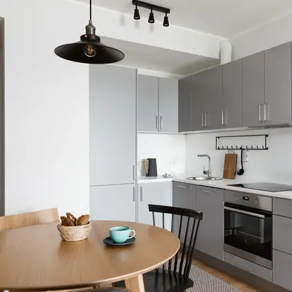 a kitchen with a table and chairs