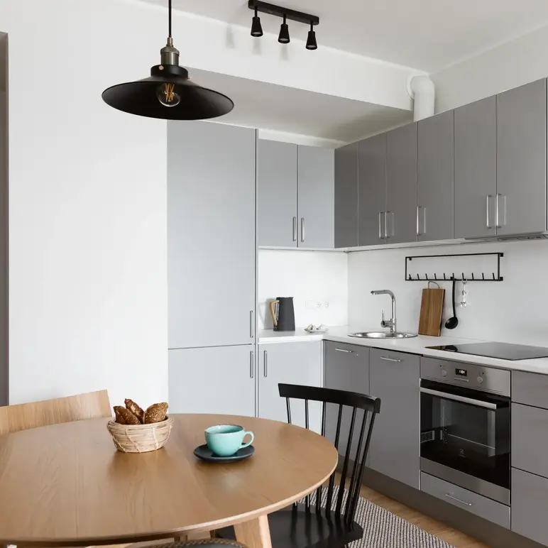 a kitchen with a table and chairs
