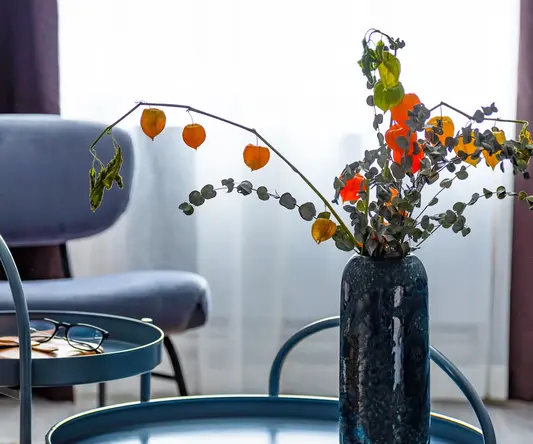a vase with flowers on a table
