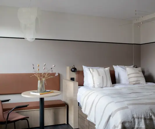 a bed with a table and chairs