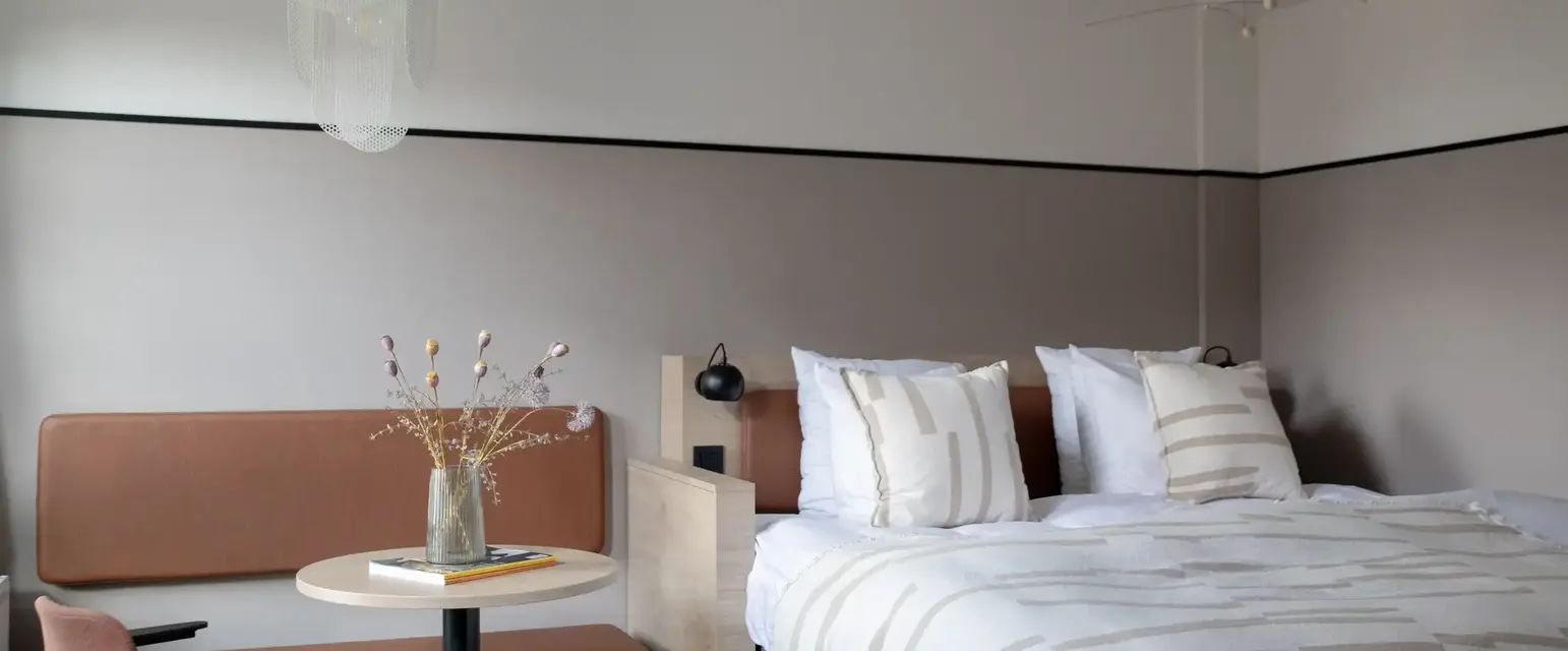 a bed with a table and chairs