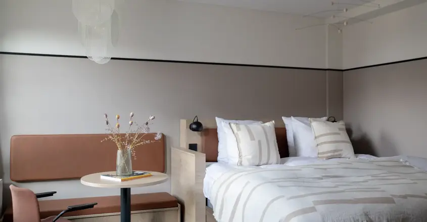 a bed with a table and chairs