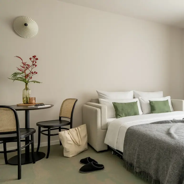 a bed with a chair and a table in a room