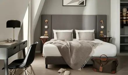 a bedroom with a bed and a desk