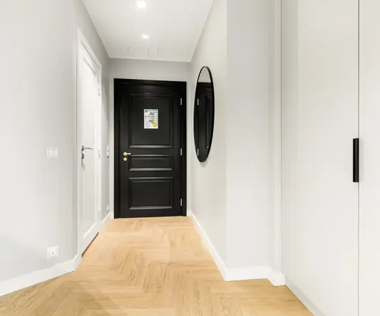 a black door in a hallway