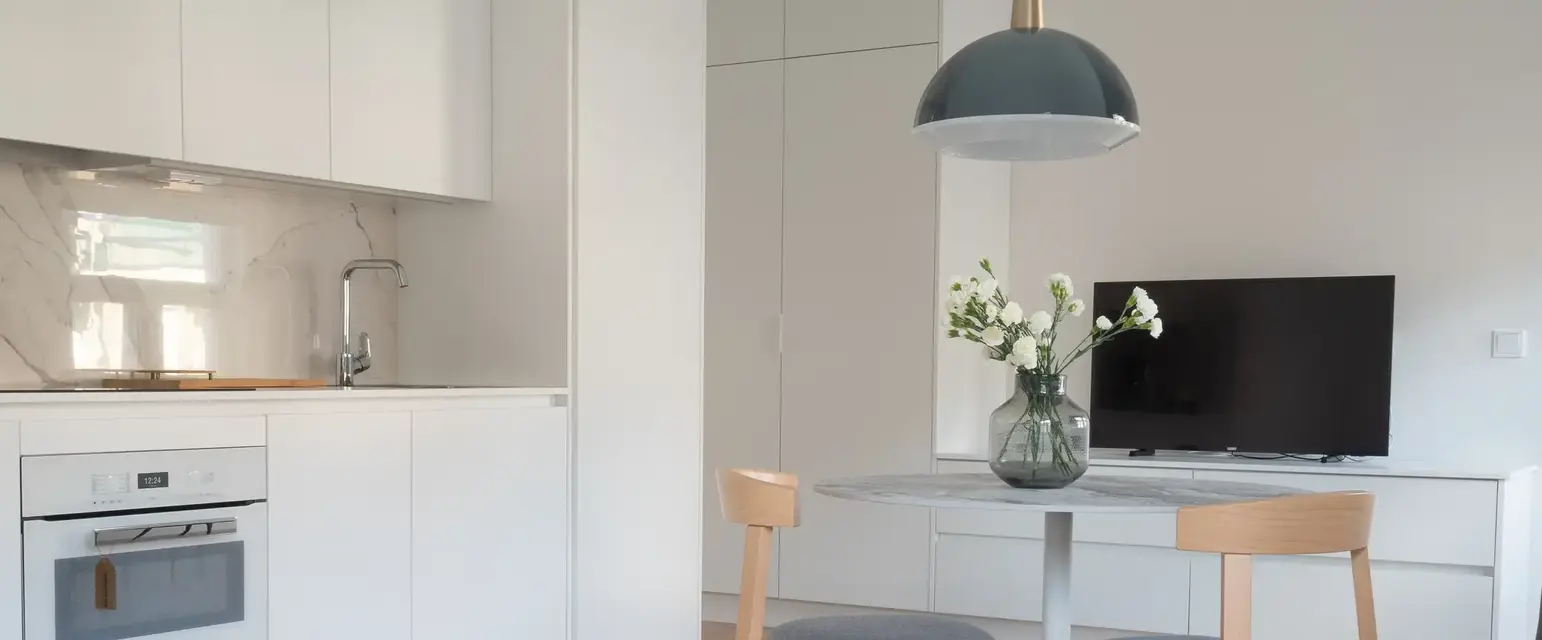 a kitchen and dining room with a table and chairs
