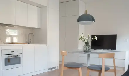 a kitchen and dining room with a table and chairs