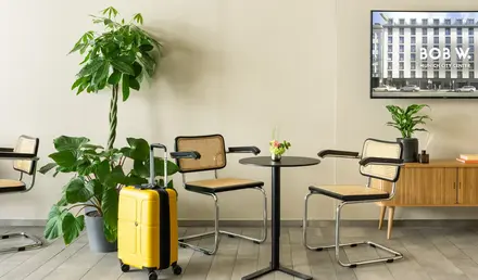 a table and chairs with a suitcase