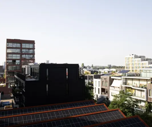 a rooftops of buildings with solar panels
