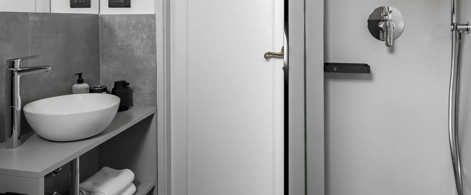 a bathroom with a shower and sink