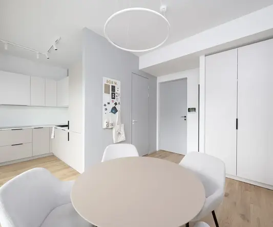 a room with a round table and chairs