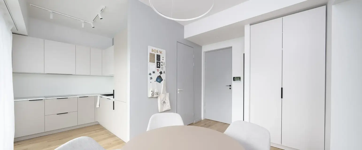 a room with a round table and chairs