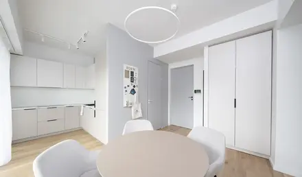 a room with a round table and chairs