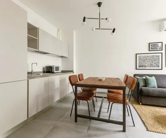 a kitchen with a table and chairs