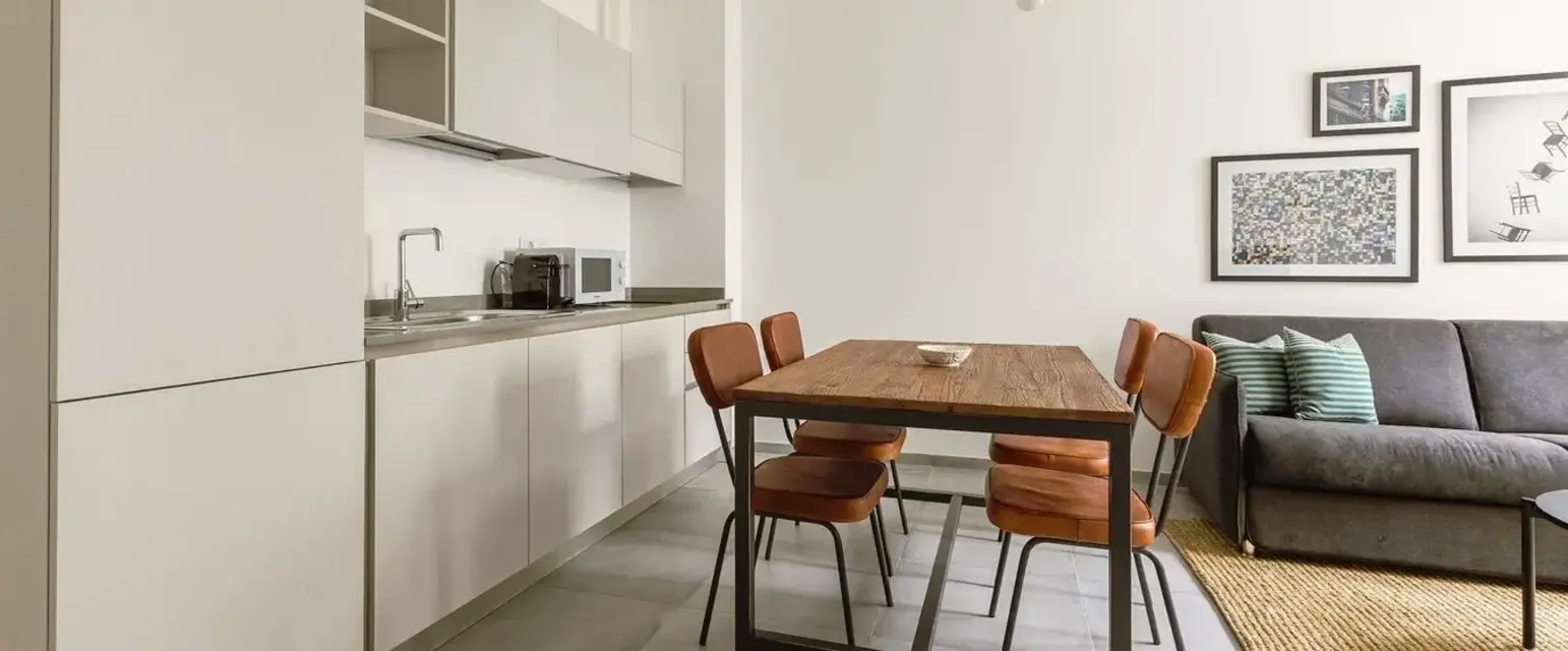 a kitchen with a table and chairs