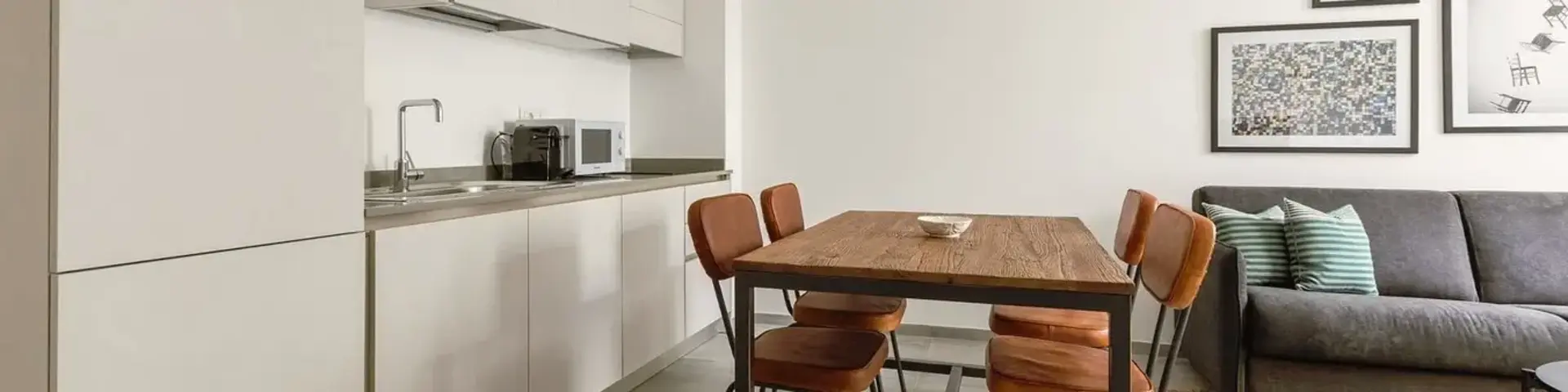 a kitchen with a table and chairs