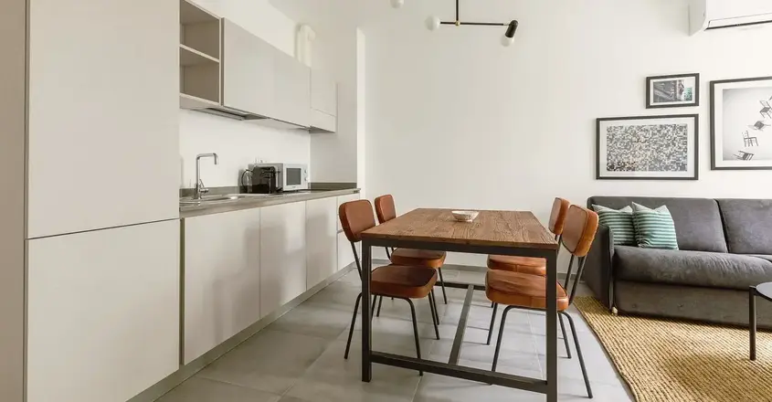 a kitchen with a table and chairs