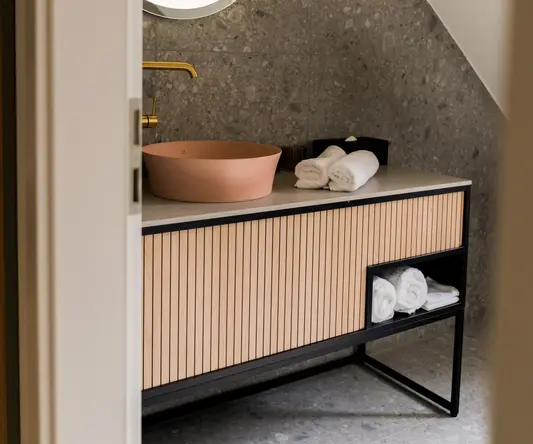 a bathroom with a round mirror and a sink