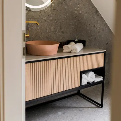 a bathroom with a round mirror and a sink