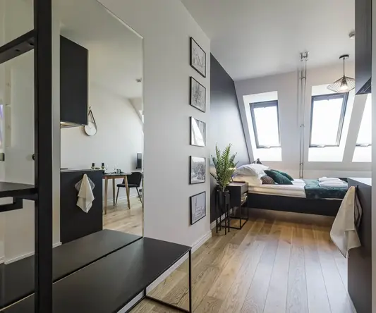 a room with a bed and a mirror