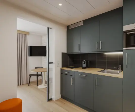 a kitchen with a table and a microwave
